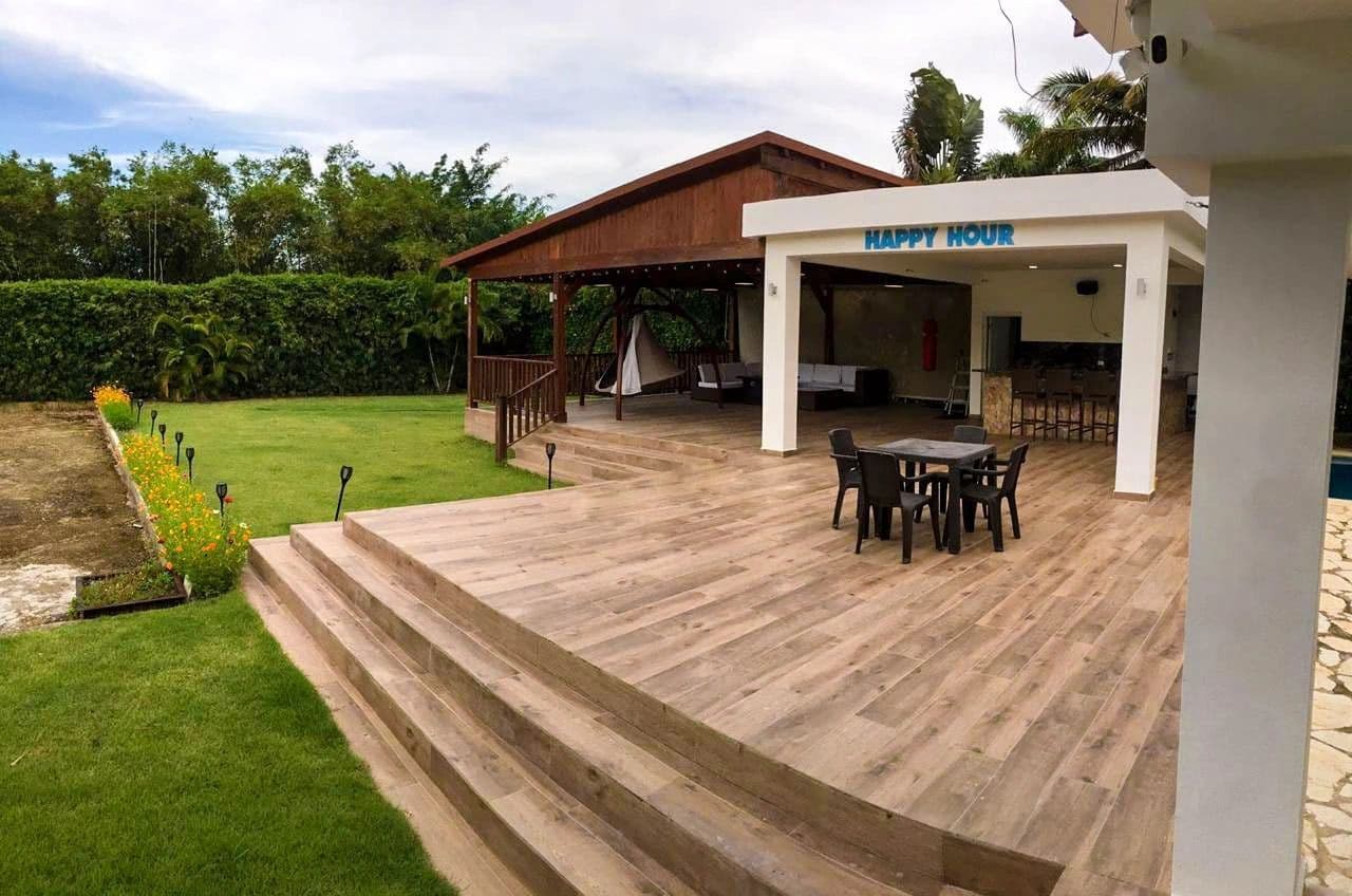 Villa outdoor bar and deck with expansive backyard