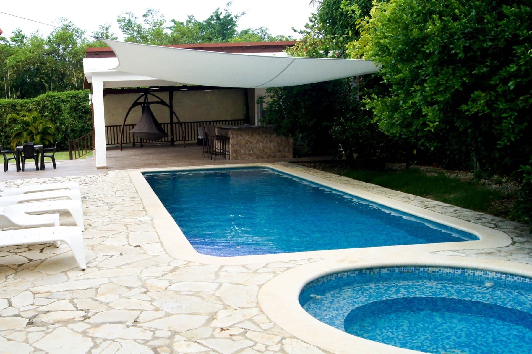 Private pool and jacuzzi surrounded by tropical greenery